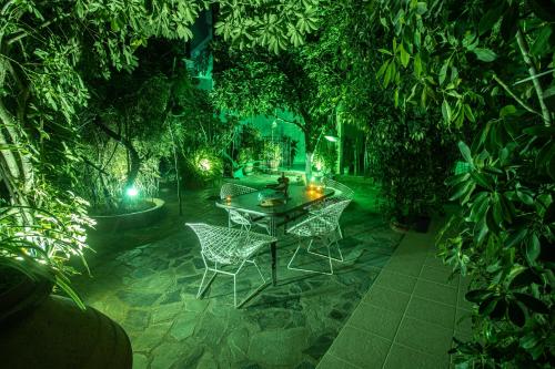 a table and chairs in a garden at night at Studios Nopi-Zoi in Skiathos Town