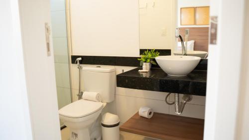 a bathroom with a toilet and a sink at Villa Moderna in Trairi
