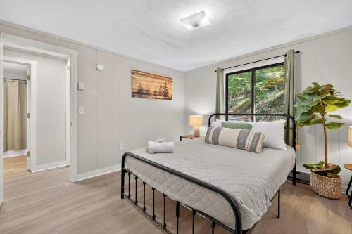 a bedroom with a bed and a large window at Chalet w Huge Deck, Grill, WiFi, Mins to Bryce! in Basye