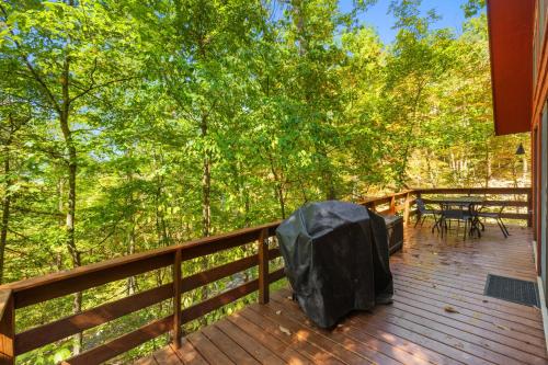 a deck with a table and chairs on it at Chalet w Huge Deck, Grill, WiFi, Mins to Bryce! in Basye