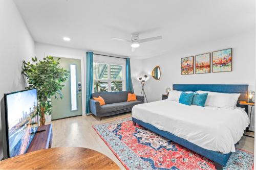 a bedroom with a large bed and a couch at Prime SoCo boutique studios with laundry WiFi 7 Min to DT in Austin