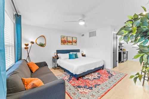 a living room with a bed and a couch at Prime SoCo boutique studios with laundry WiFi 7 Min to DT in Austin