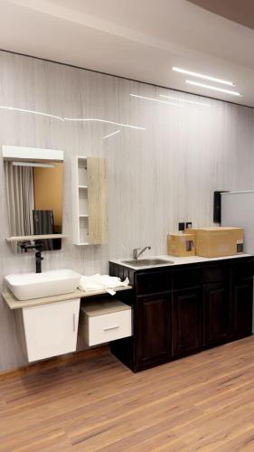 a bathroom with a sink and a mirror at شاليه الهنا in Jeddah