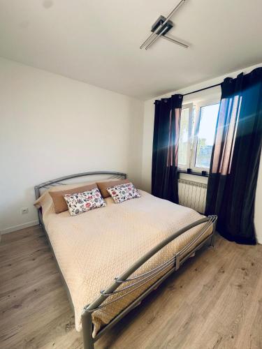 a bedroom with a bed with two pillows on it at Apartament in Tarnowskie Góry