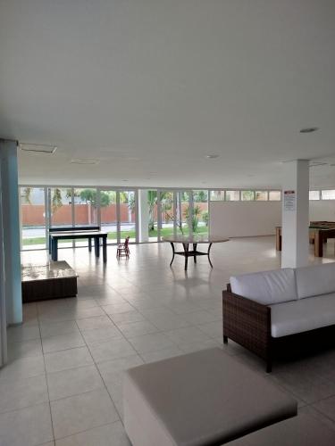 a living room with a couch and tables in a building at Apartamento boa vida in Aquiraz