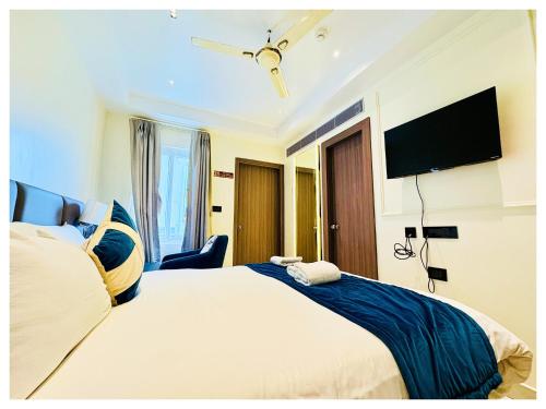a bedroom with a large bed and a flat screen tv at Front Sea View Hotel ! Eastern-Dham Near Jagannath Temple - Fully Air Conditioning Luxuray Rooms-Free Wifi & Parking Facilities- Best Hotel In Puri in Puri