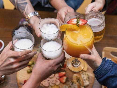 a group of people holding up a drink at ibis Styles Curitiba Aeroporto in São José dos Pinhais
