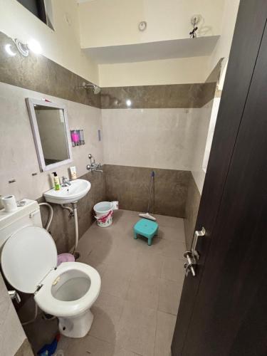 a bathroom with a toilet and a sink at The Ganges by Bella Boho in Rishīkesh