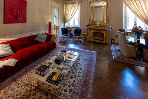 a living room with a red couch and a fireplace at Domus Tua in Modena
