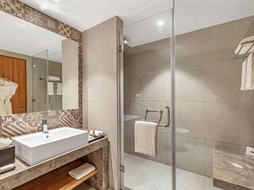 a bathroom with a sink and a shower at Grand Mercure Ahmedabad GIFT City - An Accor Hotels Brand in Gandhinagar