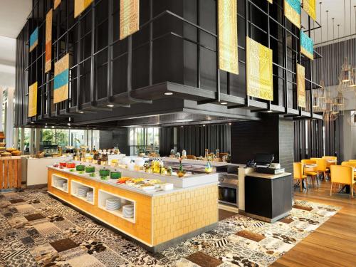 a large kitchen with a buffet in a restaurant at Grand Mercure Ahmedabad GIFT City - An Accor Hotels Brand in Gandhinagar