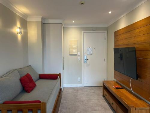 a living room with a couch and a flat screen tv at Airfamily Congonhas in Sao Paulo