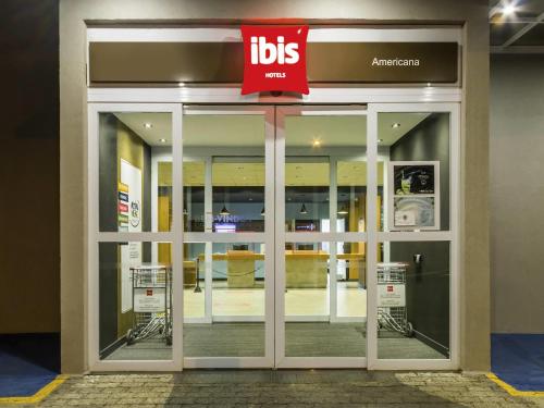 a store front with a sign on the door at Ibis Americana in Americana