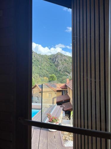 a view from a window of a pool and mountains at El Refugio II de Verdiago in Verdiago