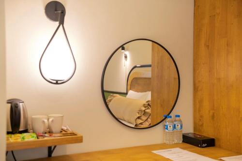 a mirror on a wall next to a table at Hotel Zon in Serdivan