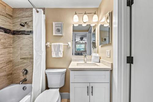 a bathroom with a sink and a toilet and a tub at The Solaster in Siesta Key