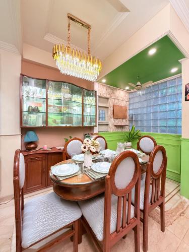 a dining room with a table and chairs at Garden Veil Luxury Villa By Spacez in Mumbai