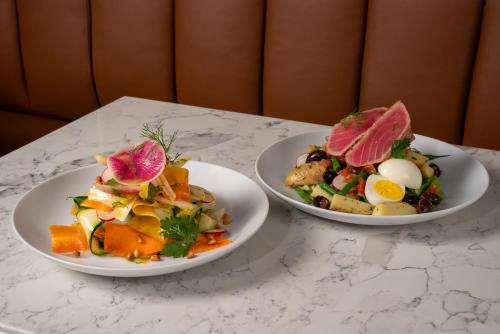 two plates of food sitting on a table at Toor Hotel Toronto, Part Of Jdv By Hyatt in Toronto