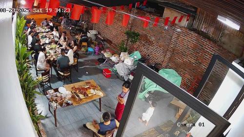 a group of people sitting at tables in a restaurant at Phố Cổ Homestay in Ninh Binh
