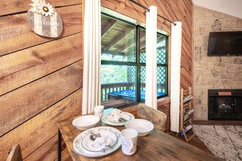 a dining room with a table and a fireplace at Cozy Sevierville Cabin W Mountain Views & Hot Tub in Sevierville