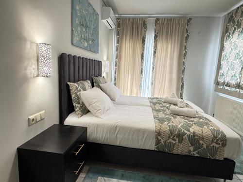 a bedroom with a large bed and a table at Castle View Trikala in Tríkala