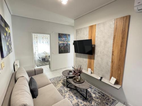 a living room with a couch and a tv at Castle View Trikala in Tríkala