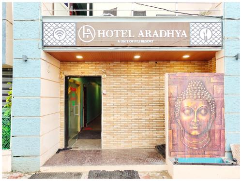 a building with a large mural of a buddha at Hotel New J-Aradhya ! Near Sea Beach And Shree Jagannath Temple - Free Wifi and Parking Facilities - Fully-Air-Conditioned Rooms - Top Rated Hotel In Puri in Puri