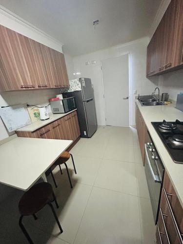 a small kitchen with a counter and a refrigerator at Departamento 3D 2B in Calama
