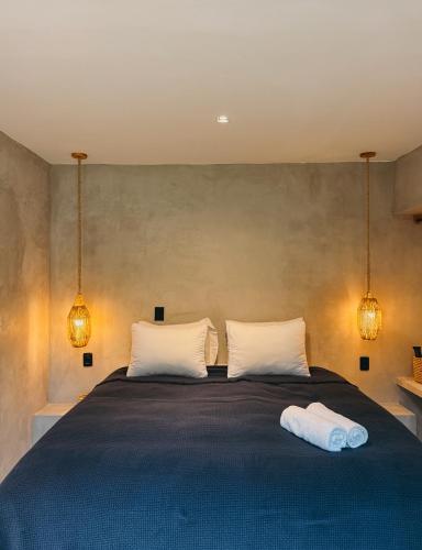 a bedroom with a large bed with two white pillows at Villa Mango Jeri in Jericoacoara