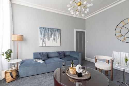 a living room with a blue couch and a table at Crescent View Central & Quiet Sleeps 4 in Scarborough