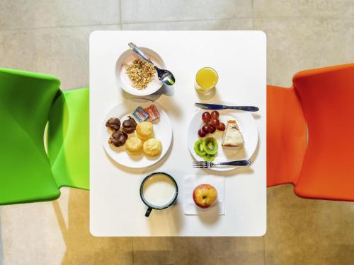 a white table with plates of food on it at ibis budget Sao Caetano in São Caetano do Sul