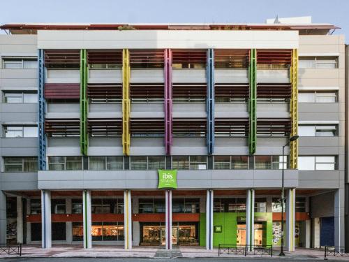 an office building with colorful ribbons on the facade at ibis Styles Athens Routes in Athens