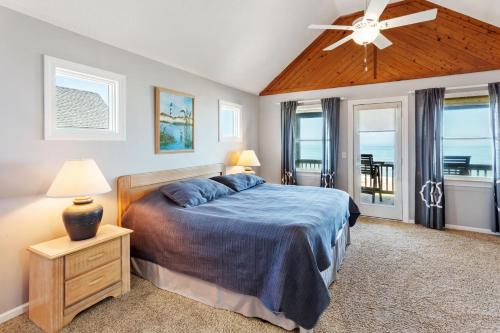 a bedroom with a bed and a ceiling fan at PW20 - Sea View in Southern Shores