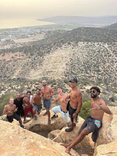 a group of men standing on top of a mountain at Bright Wave Surfhouse in Tamraght Ouzdar