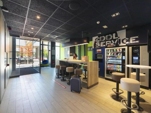 a store lobby with a bar and stools in it at ibis budget Huerta De Murcia in Murcia