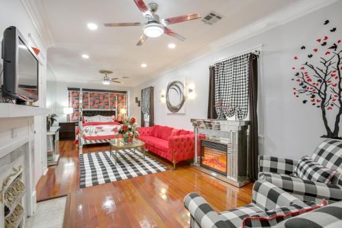 a living room with a red couch and a fireplace at 2 Mi to Audubon Park Glam NOLA Gem in New Orleans