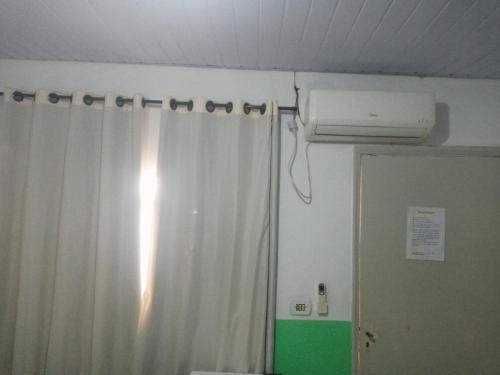 una stanza con tenda da doccia e aria condizionata di Hotel silva a Caldas Novas