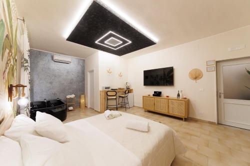 a bedroom with two beds and a television on the ceiling at Suite 45 - Relax & Comfort in Bari