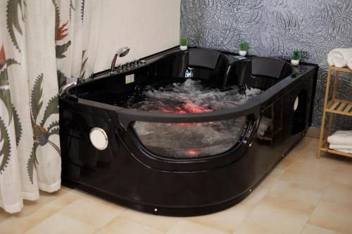 a black bathtub with a red object in it at Suite 45 - Relax & Comfort in Bari
