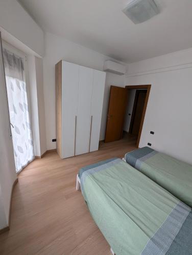 a bedroom with two beds and a large window at Rholiday in Rho