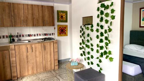a small kitchen with a sink and a bed at Apartamento central en Armenia in Armenia