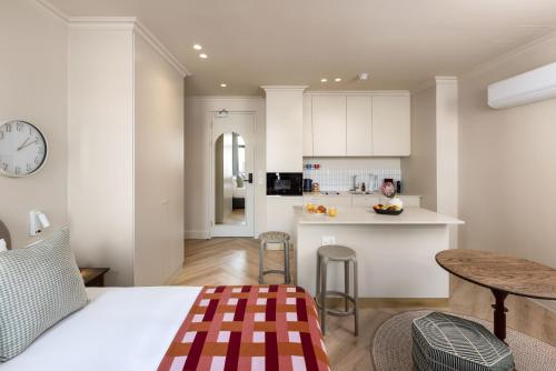 a kitchen and living room with a bed and a table at Charles Hope Boutique Hometel in Cape Town