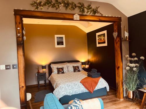 a bedroom with a bed with a wooden frame at TyCosy in St. Davids