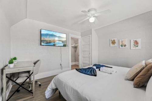 a bedroom with a bed and a desk and a ceiling fan at King Bed 2 TVs Fast Wifi Pet Friendly! in Cleveland