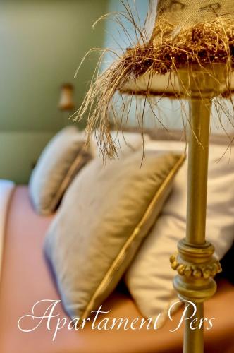 a close up of a bed with pillows and aafiasenalsenal at Apartament Pers - przytulny, klimatyzowany, z kominkiem i bezpłatnym parkingiem in Szczawno-Zdrój