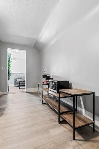 a living room with a table and a microwave at King Bed 2 TVs Fast Wifi Pet Friendly! in Cleveland