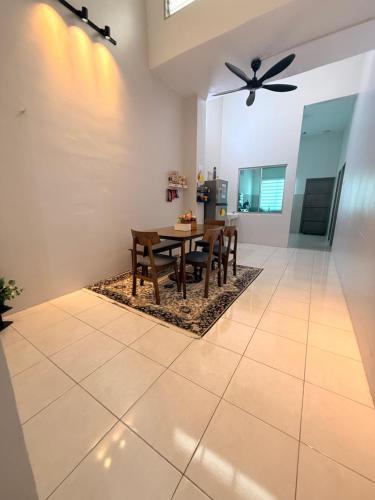 a dining room with a table and a ceiling fan at QM_Homestay Bagan Serai in Bagan Serai