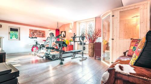 a room with a gym with exercise equipment in it at Villibera - Design villa with SPA, Cinema, Gym and Game Room in Cesano Maderno