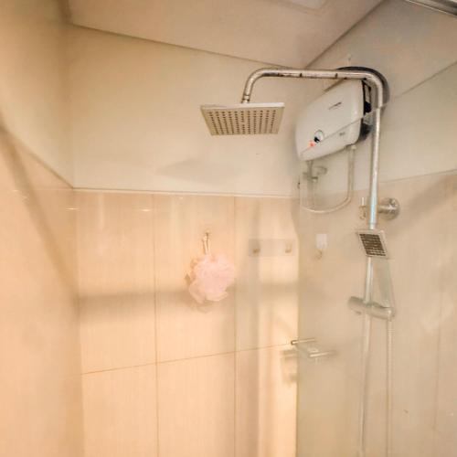 a bathroom with a shower with a shower head at Air Condo Urban Retreat 1BR w City View MOA in Manila