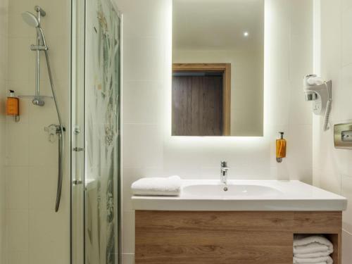 a bathroom with a sink and a shower at ibis Styles Kraków East in Kraków
